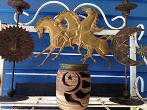 A gypsy Altar with the sun, moon, horses playing, and a beautiful earthenware jar